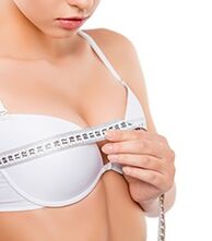 girl measuring breasts before breast augmentation